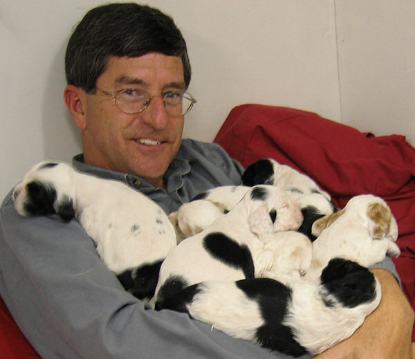 Jim Zim with an armful of puppies